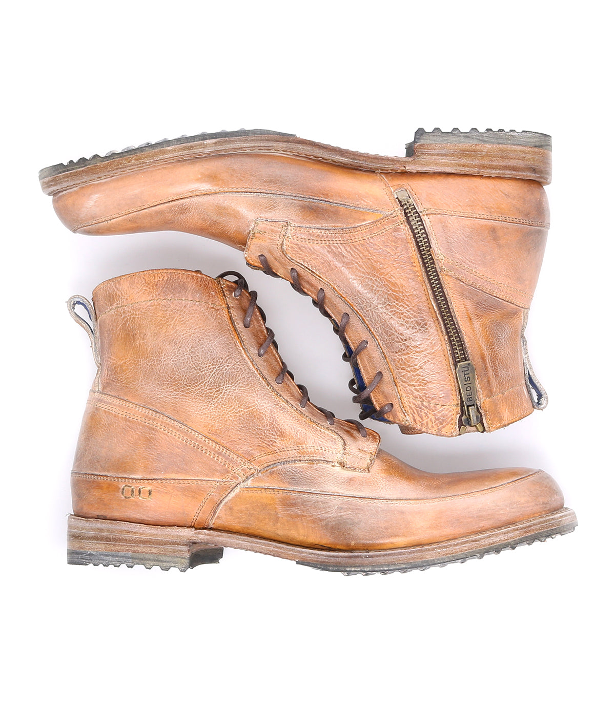 A pair of Bed|Stü Spiker brown leather ankle boots with a stacked sole, visible stitching, and side zippers. These men’s lace-up boots feature a cushioned insole for added comfort and blend rugged style with everyday wearability. Photographed on a white background.