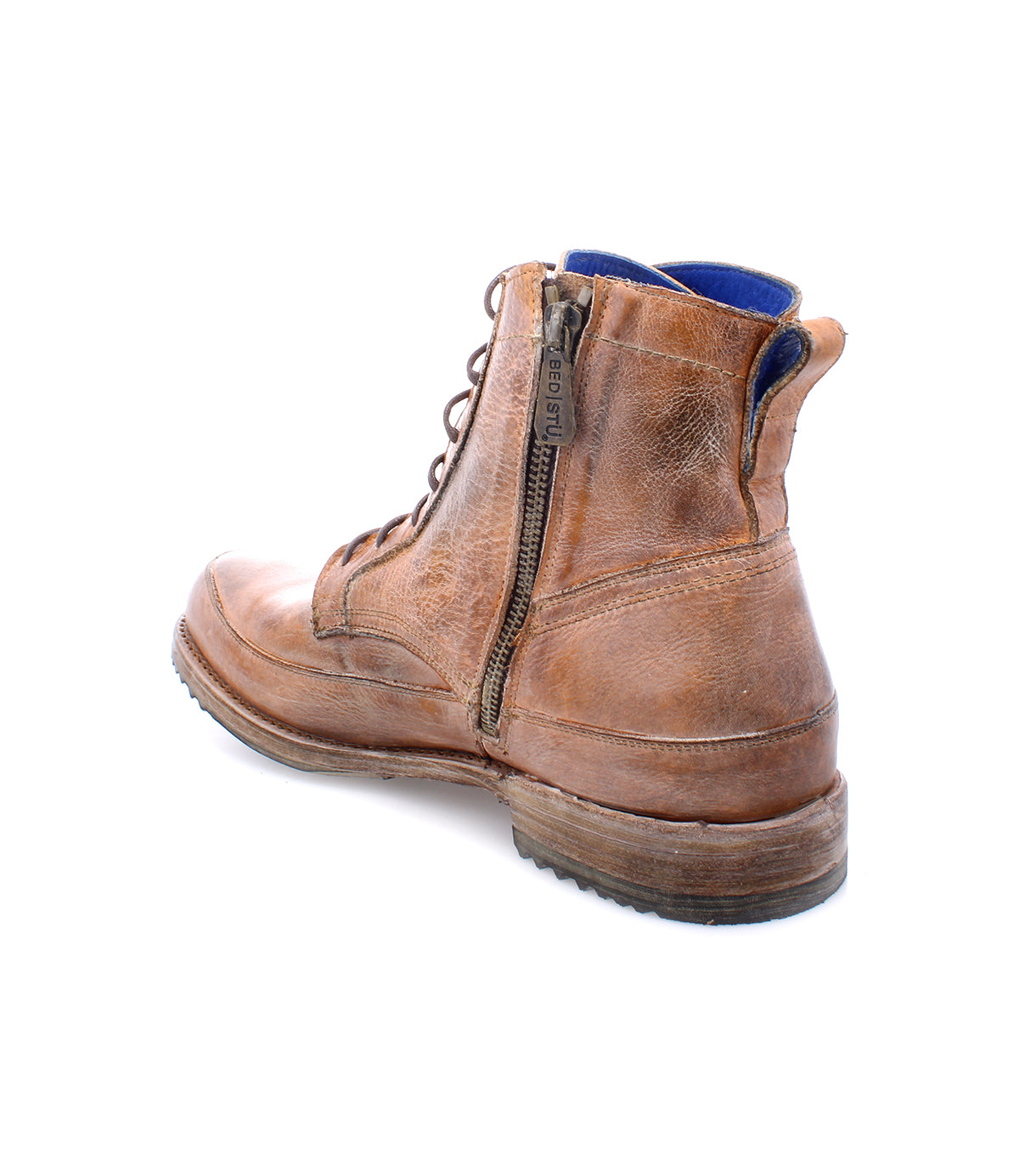 The Spiker by Bed|Stü is a brown leather ankle boot featuring a classic lace-up design, a handy side zipper, visible blue interior lining, and a worn sole. This men’s boot also includes a cushioned insole for enhanced comfort and is photographed on a white background.