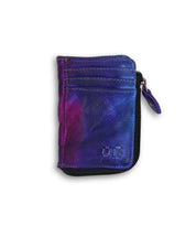 Introducing the Bed|Stü Carrie—a compact leather wallet featuring a purple and blue tie-dye pattern with two convenient card slots on the front. This stylish piece boasts a secure zip compartment along its edge, all showcased against a clean white background.