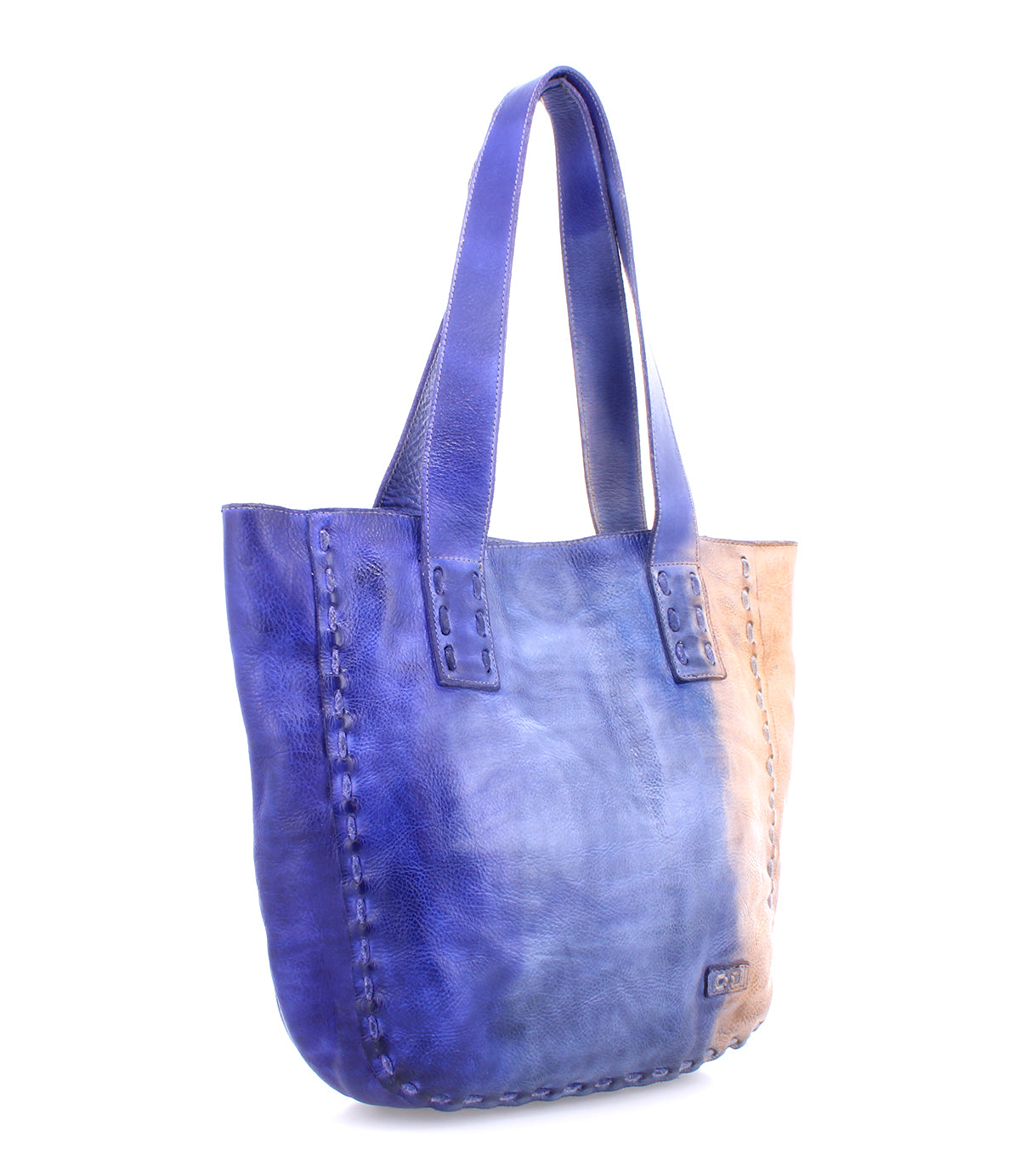 Introducing the Stevie by Bed|Stü—a leather tote bag with wide handles, featuring a striking blue-to-tan gradient design and visible stitched seams along the sides and base. Perfect for everyday carry or anyone seeking a touch of vintage bag charm.
