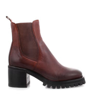 The Surge by Bed|Stü is a brown Italian leather ankle boot in the classic Chelsea style, featuring textured elastic side panels, a chunky heel, and a ridged black rubber sole.
