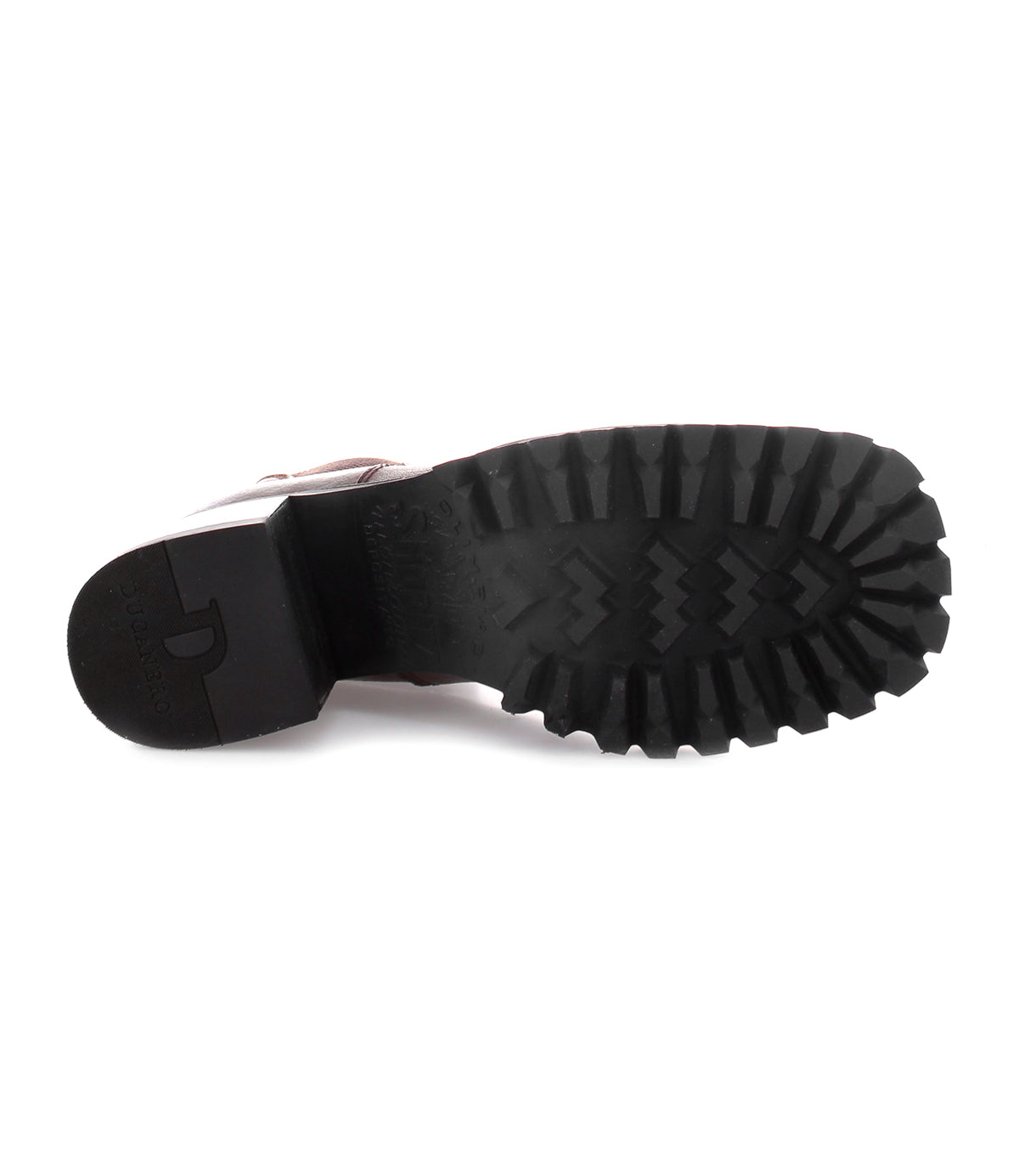 The image shows the bottom view of a single Bed|Stü Surge boot with a square toe and a thick black rubber sole featuring deep, rugged treads.