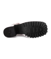 The image shows the bottom view of a single Bed|Stü Surge boot with a square toe and a thick black rubber sole featuring deep, rugged treads.