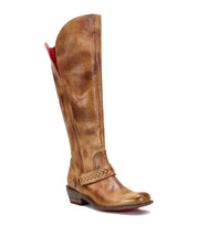 The Takoma boot by Bed|Stü is a tall brown leather boot featuring a red inner lining, decorative stitching on the side strap, a low western-shaped heel, and a square toe, photographed on a white background.