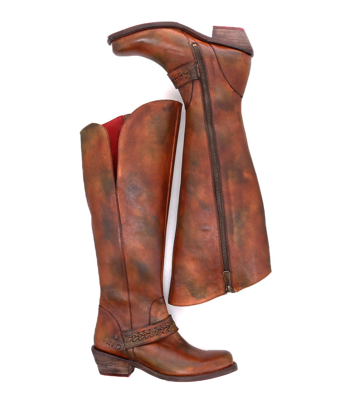 A pair of Takoma tall brown leather western boots by Bed|Stü is shown, with one boot standing upright and the other on its side, highlighting the zipper and red lining. These boots feature a stylish square toe and a classic western-shaped heel, blending timeless design with modern comfort.