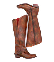 A pair of Takoma tall brown leather western boots by Bed|Stü is shown, with one boot standing upright and the other on its side, highlighting the zipper and red lining. These boots feature a stylish square toe and a classic western-shaped heel, blending timeless design with modern comfort.