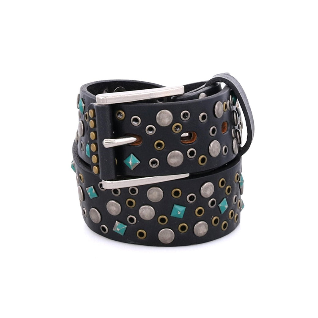 The Bed|Stü Tammin belt, coiled against a white background, features round metal studs and turquoise square studs with a silver interchangeable buckle for versatile styling.