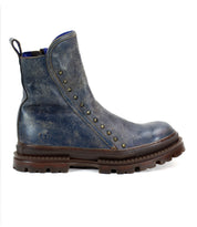 The Tanto boot by Bed|Stü is a streamlined blue design featuring a leather upper, rugged lug outsole, and decorative metal studs along the side.
