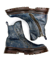 A pair of worn blue Bed|Stü Tanto leather boots with a streamlined silhouette, brown soles, metal studs, and a visible side zipper, arranged side by side on a white background.