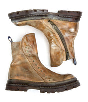 A pair of Bed|Stü Tanto worn brown leather boots featuring side zippers, metal studs, chunky lug soles, and noticeable signs of use.