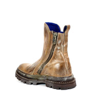 The Bed|Stü Tanto boot, shown from the back on a white background, features a worn brown leather upper, thick lug outsole, and a convenient side zipper.