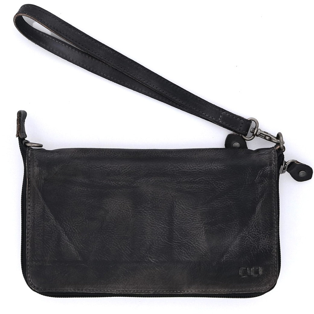 The Bed|Stü Templeton II, a black leather wristlet clutch with a zipper closure and detachable wrist strap, is showcased on a white background and effortlessly transitions from a sleek wallet to a chic crossbody for versatile styling.
