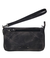 The Templeton II by Bed|Stü is a black leather wristlet featuring a front zipper pocket and a detachable wrist strap, shown against a white background.