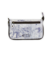 Introducing the Templeton II by Bed|Stü: a rectangular clutch in marbled white and purple leather, featuring a front white button snap, metal plate detailing, and a convenient zipper pocket—photographed on a white background. This stylish accessory effortlessly combines wallet elegance with the practicality of a crossbody.