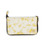 Introducing the Templeton II by Bed|Stü—a rectangular clutch purse featuring a striking yellow and white marbled pattern, brown edges, and a convenient zippered top closure. Perfect for use as a stylish wallet or a compact leather crossbody.