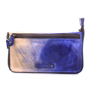 The Templeton II by Bed|Stü is a rectangular leather clutch with a front zipper pocket, featuring a striking color gradient from beige to blue and adorned with a visible Bed|Stü logo patch; this versatile accessory effortlessly doubles as a wallet for added convenience.