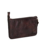 The Templeton II by Bed|Stü is a brown leather zippered clutch with a wrist strap, featuring their embossed logo in the lower right corner—a versatile wallet that seamlessly blends elegant style with practical functionality.
