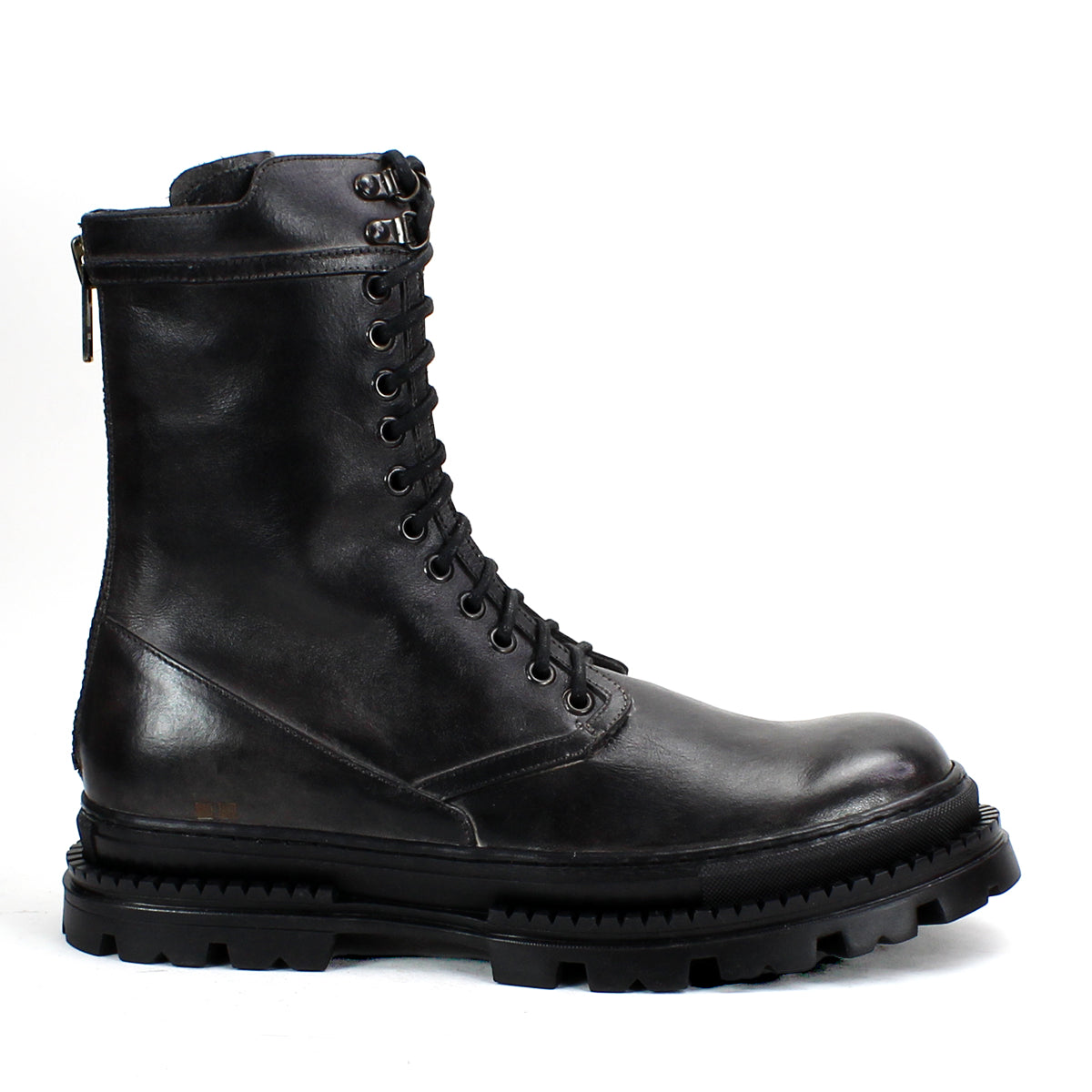 The Tempt boot by Bed|Stü is a black leather lace-up combat boot with a thick, rugged sole and a convenient side zipper, shown in profile on a white background—this stylish hybrid fuses classic combat and Chelsea boot details for versatile appeal.