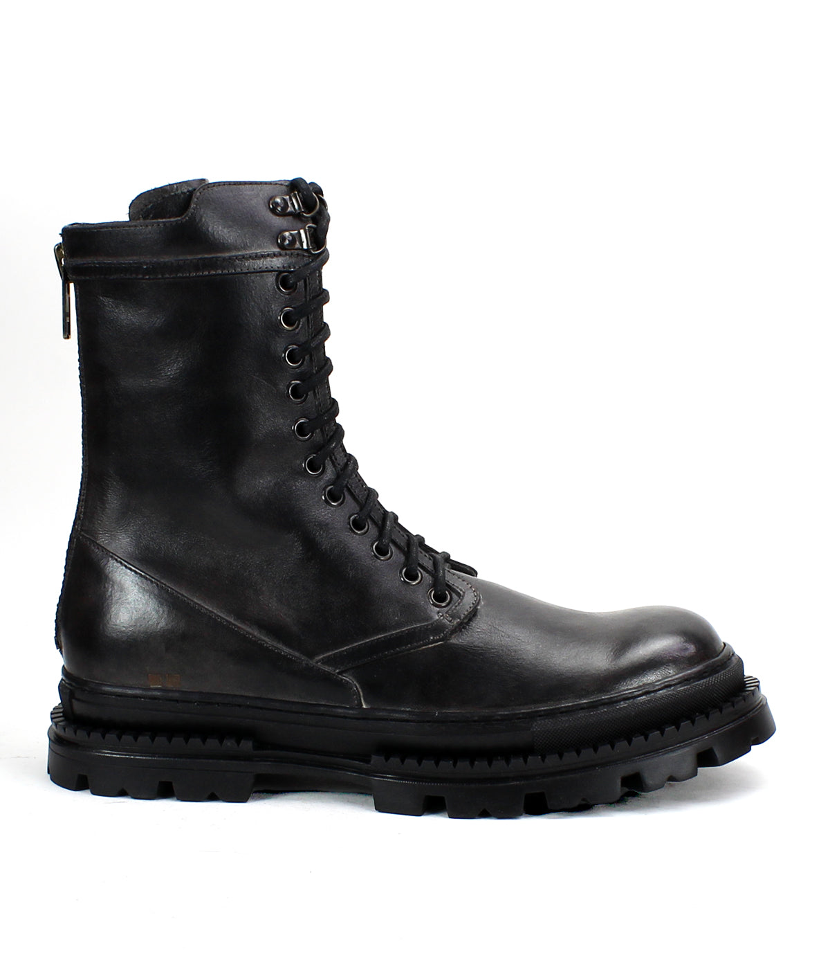 The Tempt boot by Bed|Stü is a black leather lace-up combat boot with a thick, rugged sole and a convenient side zipper, shown in profile on a white background—this stylish hybrid fuses classic combat and Chelsea boot details for versatile appeal.