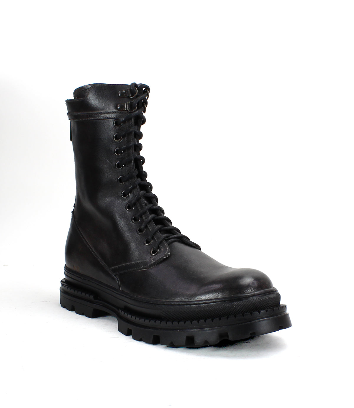 The Bed|Stü Tempt is pictured against a plain white background, showcasing its stylish hybrid design that combines elements of a classic combat boot and a Chelsea boot, featuring black leather, lace-up detailing, and a thick, rugged sole.