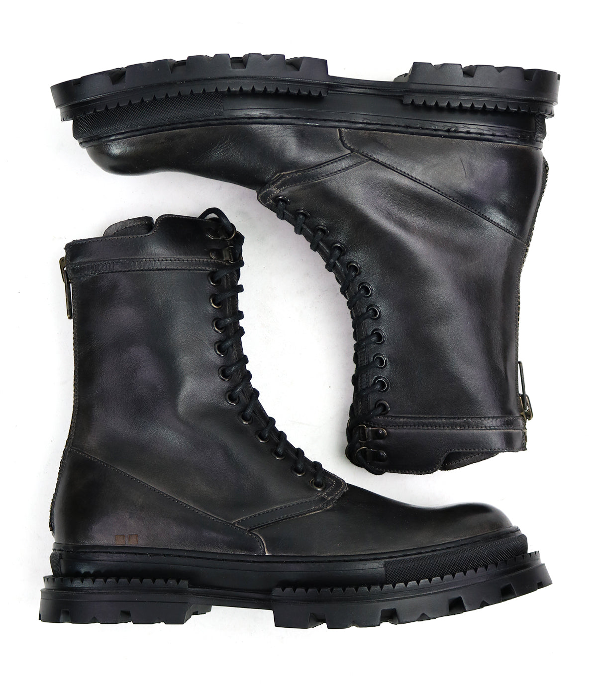 A pair of Tempt black lace-up combat boots by Bed|Stü, featuring thick, rugged soles and a sleek Chelsea boot silhouette—shown side by side and stacked—these stylish hybrids offer the durability of hiking boots with modern design, set against a white background.