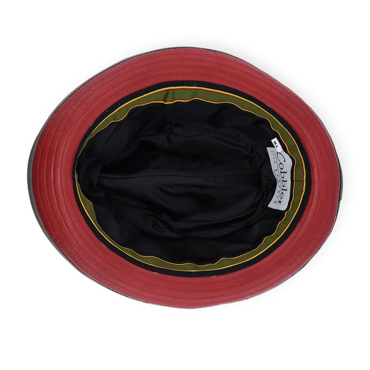Top-down view of the inside of the Turino bucket hat by Bed|Stü in red, black, and green, featuring a lightweight black inner lining and a visible "Bed|Stü" brand label.