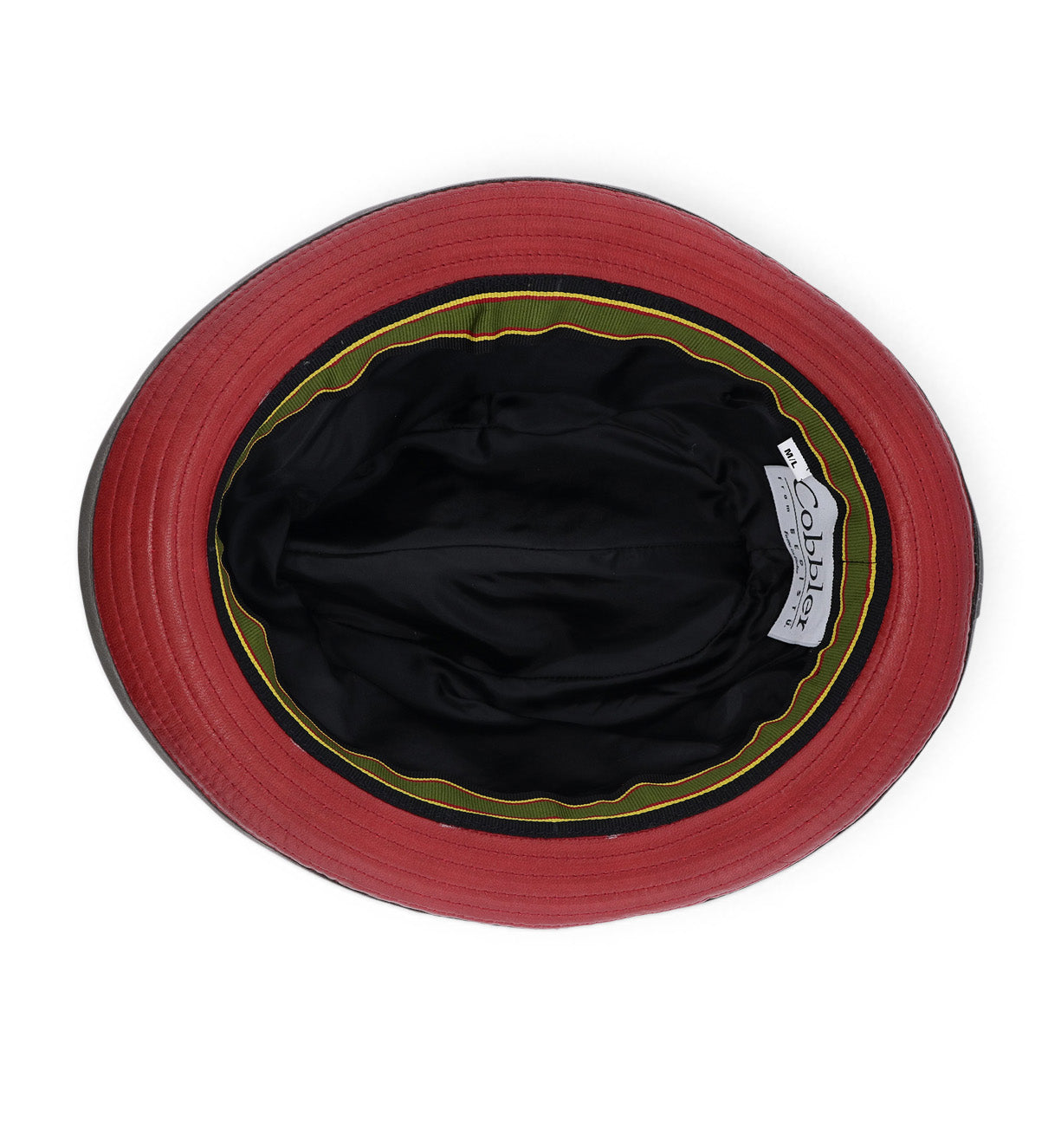 Top-down view of the inside of the Turino bucket hat by Bed|Stü in red, black, and green, featuring a lightweight black inner lining and a visible "Bed|Stü" brand label.