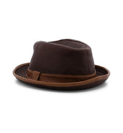 The Bed|Stü Turino is a lightweight, brown fedora hat with a matching brown band, shown from the side against a white background. This crushable, handmade leather hat blends classic style and practical durability.