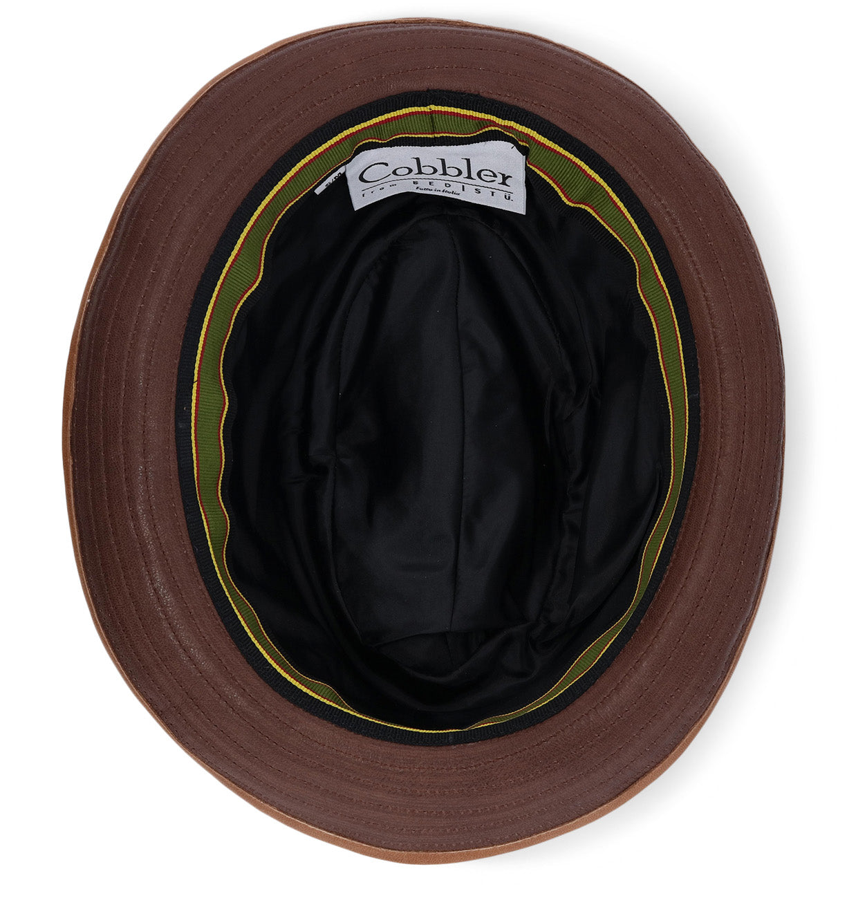 A brown bucket hat, the Turino by Bed|Stü, is shown from above, revealing a black inner lining and a label that reads "Cobbler." This crushable, lightweight design ensures everyday comfort while offering the refined look of a handmade leather hat.