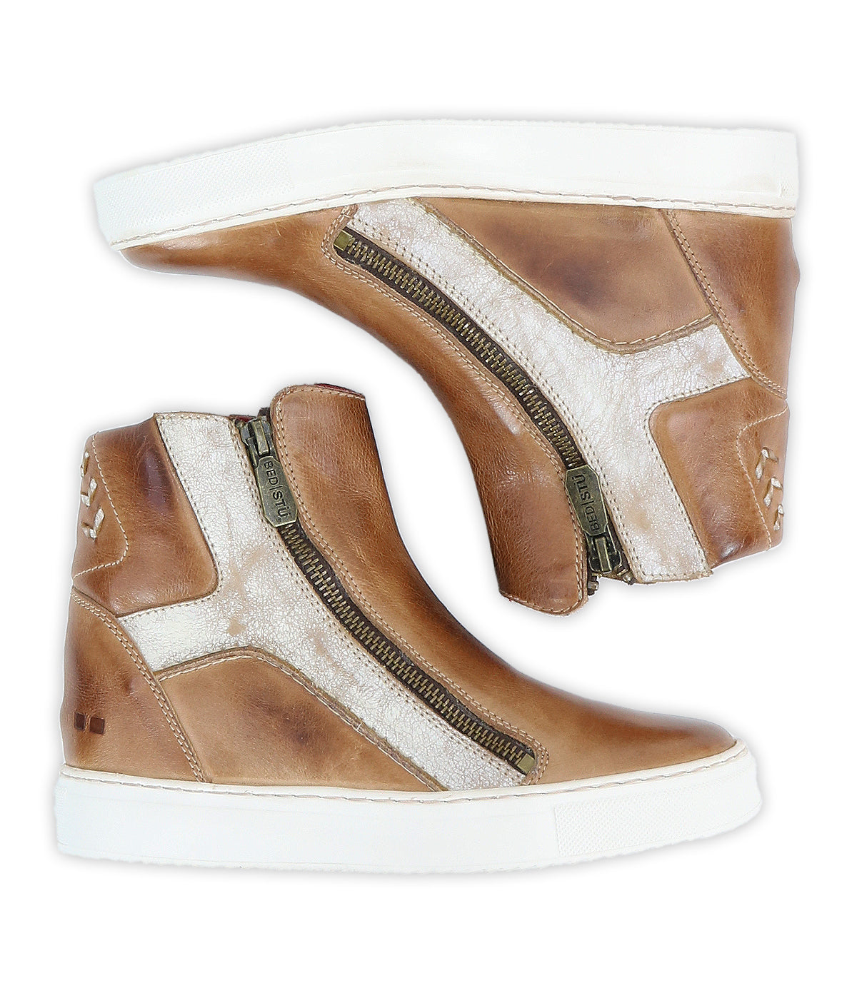 Two brown high top sneakers, the "Twist" by Bed|Stü, crafted with leather panels and featuring white accents, side zippers, and white rubber soles, are displayed side by side against a white background.