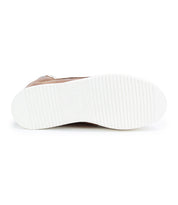 The image displays the bottom view of the Bed|Stü Twist high top sneaker, featuring a white, ribbed rubber sole and a light brown upper visible along the side. Subtle leather panels enhance the texture and style of this unique design.