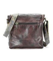 The Bed|Stü Venice Beach is a brown full-grain leather crossbody bag featuring a front zippered pocket and a distressed adjustable strap, displayed against a white background.