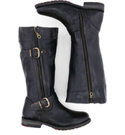 A pair of Bed|Stü Gogo Lug Wide Calf boots shown from a side and bottom view, featuring tall black leather uppers, side zippers, decorative buckles, low stacked heels, and a classic engineer boot silhouette.