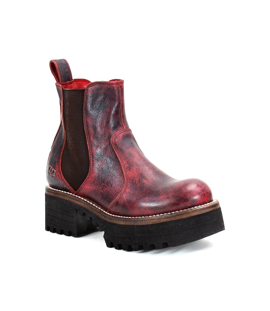 A single Valda Hi boot by Bed|Stü, featuring red leather, a comfortable platform sole, brown elastic side panel, thick textured sole, and a pull tab, shown on a white background.