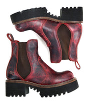 A pair of Valda Hi red distressed leather Chelsea boots by Bed|Stü, featuring black elastic side panels, comfortable platform soles, and pull tabs, shown from the side and sole view.