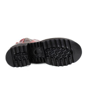 The image displays the bottom sole of the Bed|Stü Valda Hi, a black Chelsea boot featuring deep tread patterns and a comfortable platform sole, positioned facing upward on a white background.