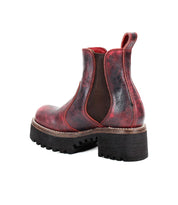 A single Valda Hi Chelsea boot by Bed|Stü, featuring red and black leather, a comfortable platform sole, chunky heel, and thick tread, shown from the back and isolated on a white background.