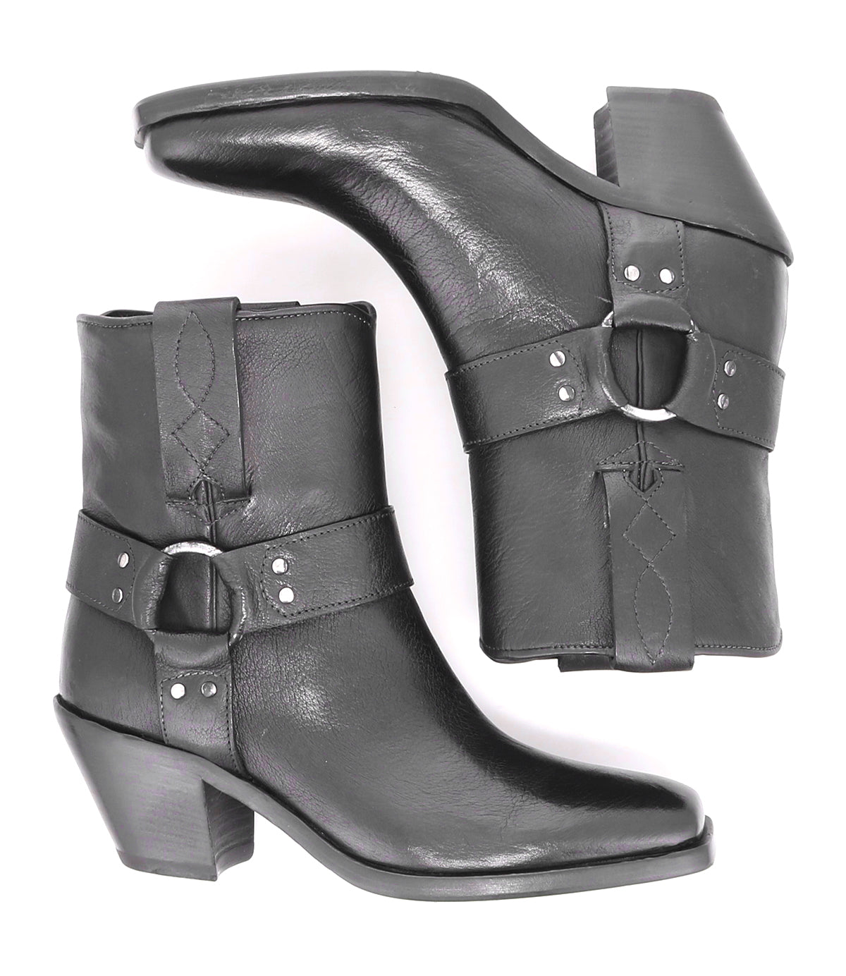 A pair of Vamoose black Italian leather cowboy ankle boots by Bed|Stü, featuring side decorative straps and silver buckles in a classic harness-boot style, shown from the side and top views.