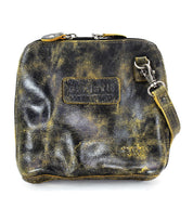 Introducing the Ventura by Bed|Stü: a lightweight black and yellow leather crossbody bag featuring a zippered top, detachable strap, rectangular embossed patch on the front, and an exterior zip pocket for added convenience.
