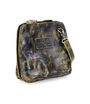 The Bed|Stü Ventura is a small, distressed black and yellow leather zippered pouch with a wrist strap and a rectangular patch on the front. This versatile design can be used as a lightweight purse or as an exterior zip pocket for your favorite leather crossbody bag.