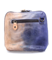The Ventura by Bed|Stü is a small, lightweight leather purse featuring a front zipper pocket, a faded tan and blue color pattern, and a metal ring attachment.