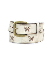 The Bed|Stü Wander belt, crafted from light-colored leather, features a brass buckle and evenly spaced brown butterfly designs adorning the strap; this whimsical accessory is pictured coiled.