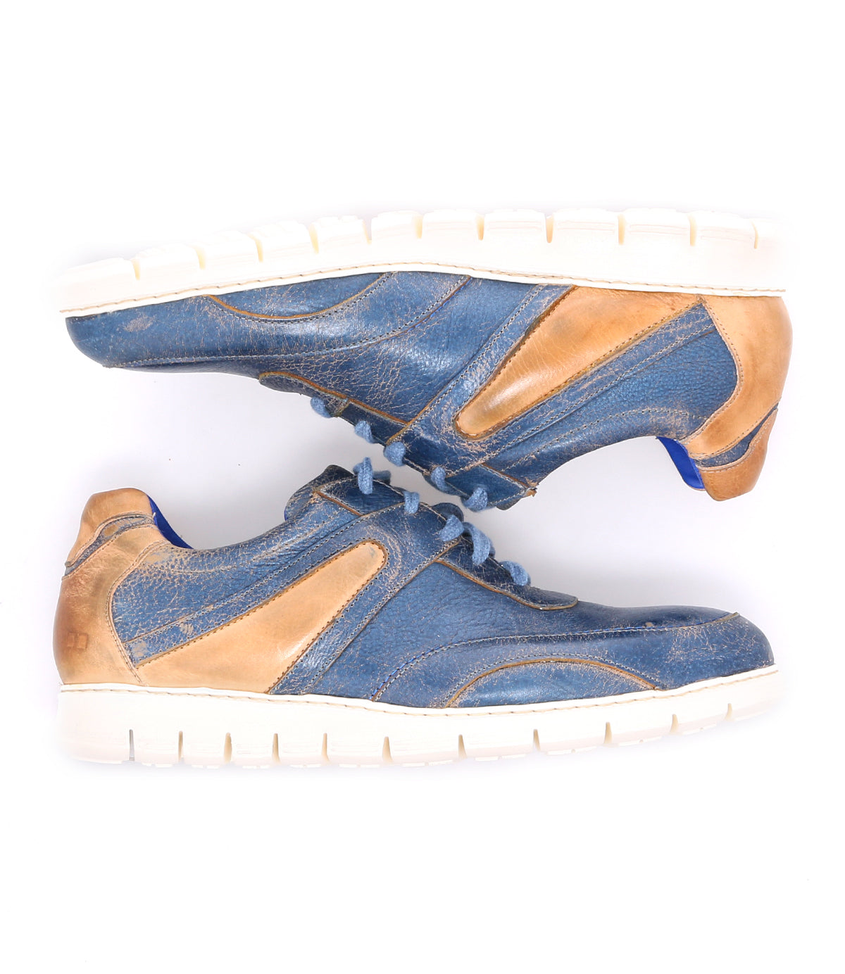 A pair of Bed|Stü Wardell blue and tan layered leather sneakers with cushioned soles, positioned side by side on a white background, offering a modern edge to classic athletic style.