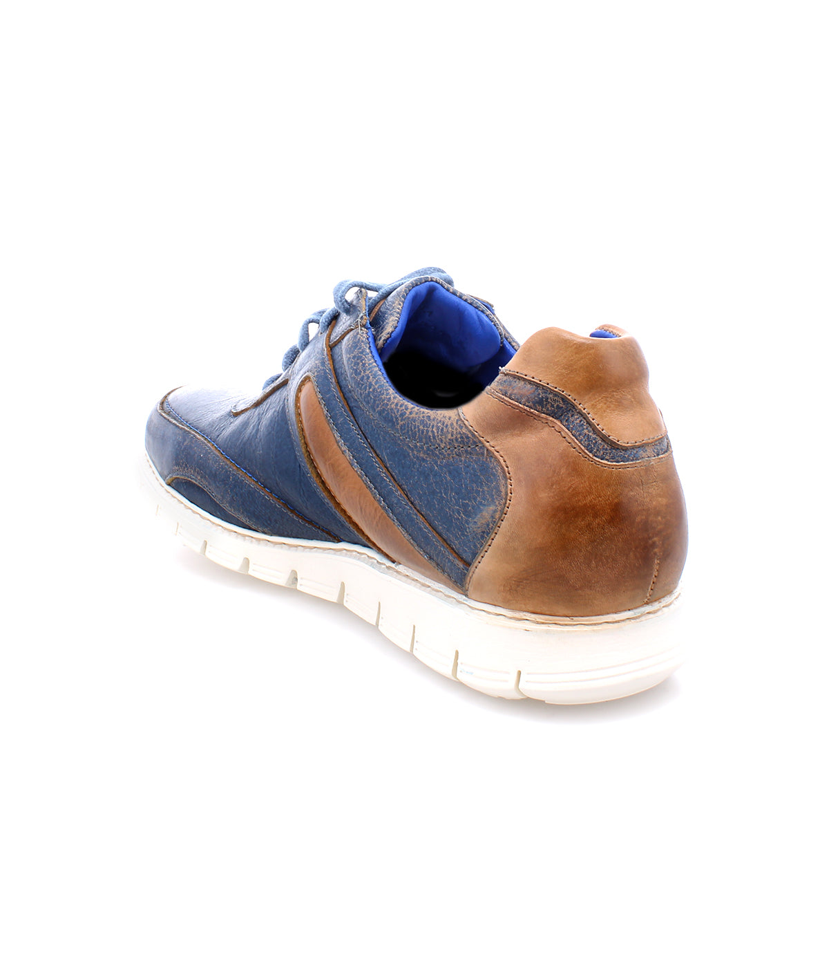 The Bed|Stü Wardell is a blue and brown layered leather sneaker with a white, cushioned sole, shown from the back and side against a plain white background to highlight its modern edge.