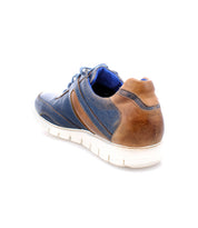 The Bed|Stü Wardell is a blue and brown layered leather sneaker with a white, cushioned sole, shown from the back and side against a plain white background to highlight its modern edge.