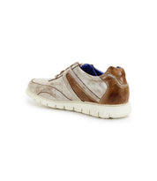 The Wardell sneaker by Bed|Stü features brown and beige layered leather, a cushioned sole, and a white outsole. Shown at an angled back and side view on a white background, this contemporary design brings a modern edge to your everyday style.
