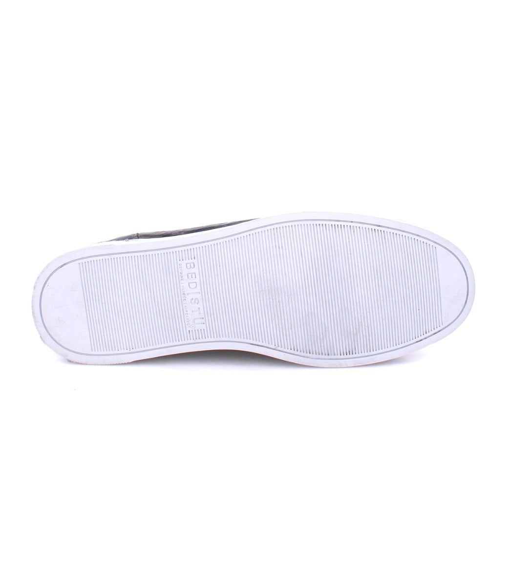 The image shows the sole of a white, low-profile leather sneaker from Bed|Stü's Wizard line, featuring fine horizontal tread lines and the embossed text "Wizard 41½.