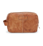 The Yatra is a brown leather toiletry bag from Bed|Stü, featuring a side handle, a secure zipper closure, and the embossed Bed|Stü logo on the front. Compact in size, this versatile bag doubles as a stylish travel organizer—perfect for keeping your essentials neatly arranged wherever you go.