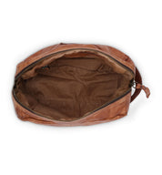 The Bed|Stü Yatra is an open brown leather toiletry bag with a zipper, revealing its empty, fabric-lined interior against a white background—an ideal compact travel organizer for your essentials.