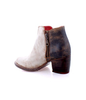 Side view of the Bed|Stü Yell women's ankle boot, showcasing a white front, brown distressed heel, side zipper, and chunky heel on a white background—expertly crafted, handmade leather boots with a durable Vibram outsole.